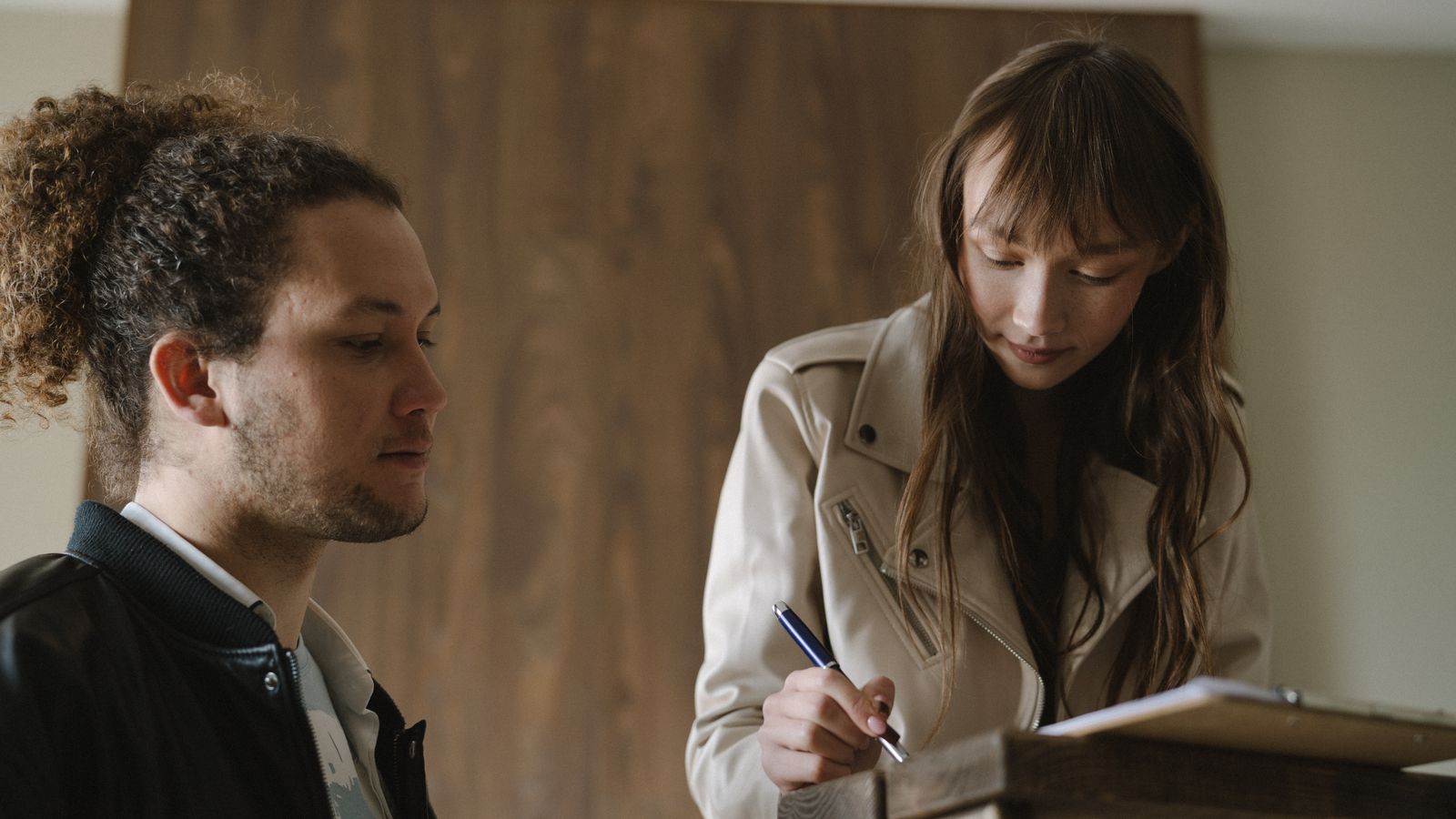 Landlord and tenant reviewing a rent agreement together